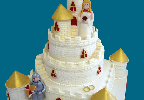A wedding cake in the shape of a castle and princess